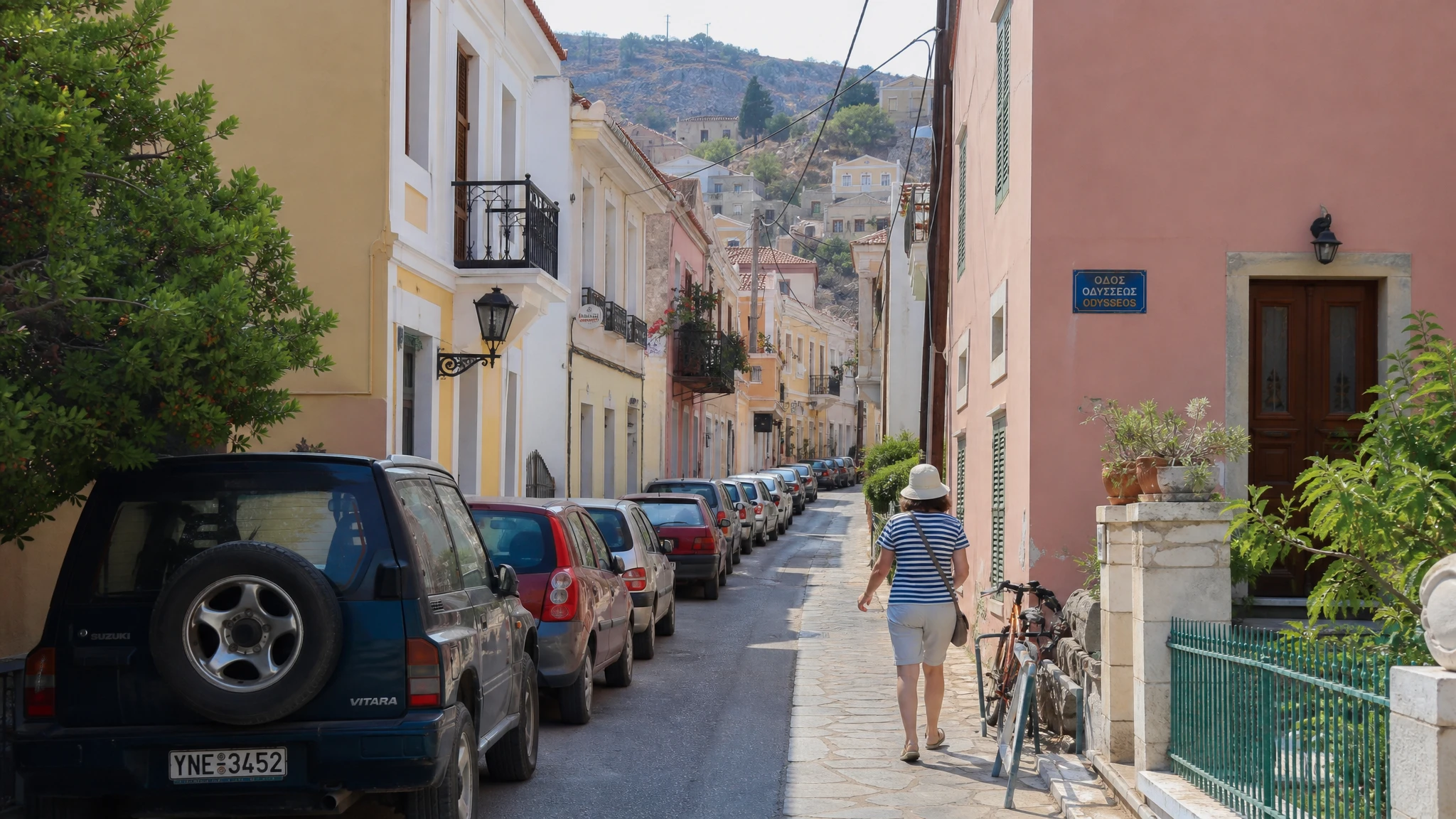 Vista de calle residencial estrecha con tráfico de vehículos en núcleo urbano